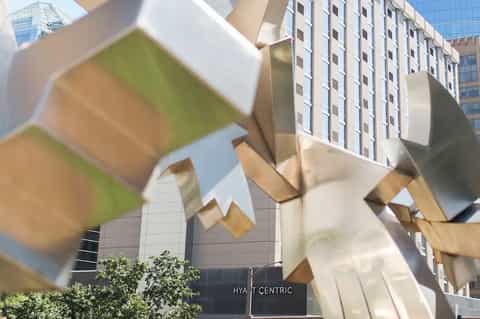 Hyatt Centric hotel exterior with modern architectural sculptural elements and tall residential buildings