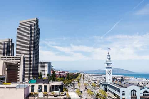 San Francisco cityscape featuring Ferry Building clock tower and bay waterfront view