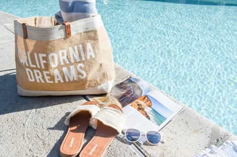 California Dreams tote bag with sunglasses and magazines poolside