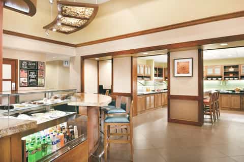 Bakery café interior with wood accents, display cases, and seating area with Starbucks signage