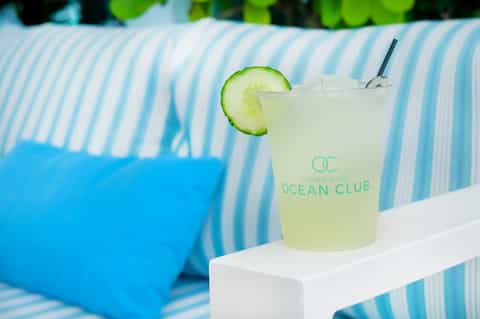 Poolside cocktail with cucumber garnish at Condado Ocean Club