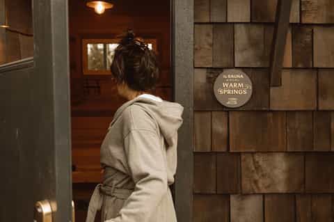 Guest entering warm springs sauna facility at hotel spa