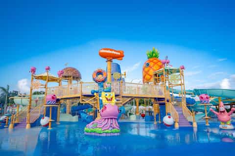Colorful Nickelodeon water park with pineapple-shaped play structures
