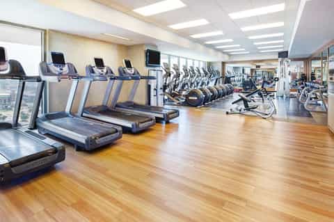 Modern fitness center with treadmills, exercise bikes, and equipment