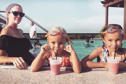Family enjoying refreshing beverages at beachside pool bar
