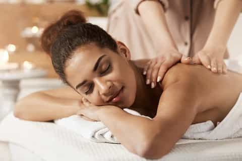 Woman receiving a relaxing spa massage treatment in a wellness center