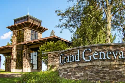Grand Geneva resort entrance with stone tower and signage
