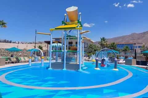 Colorful water park with blue splash pool and interactive water features