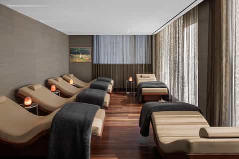 Spa relaxation room with massage beds and ambient salt lamp lighting