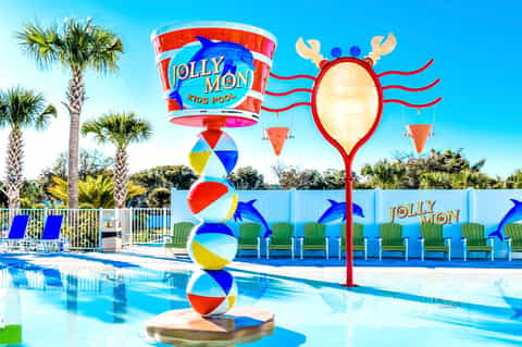 Jolly Mon kids pool with colorful beach balls, palm umbrellas, and whimsical water feature