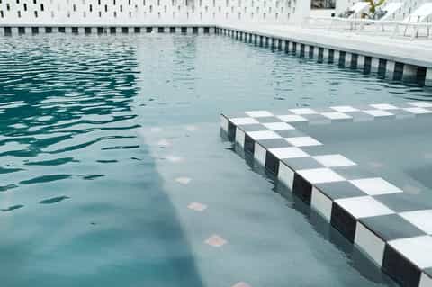 Modern lap pool with geometric deck pattern and minimalist design
