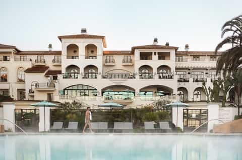 Elegant beachfront resort with Spanish architecture and infinity pool overlooking ocean