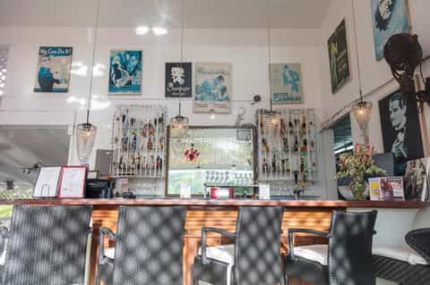 Vintage-style cafe counter with retro posters and pendant lighting