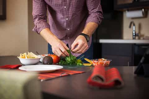 Chef preparing fresh vegetables and ingredients on kitchen counter