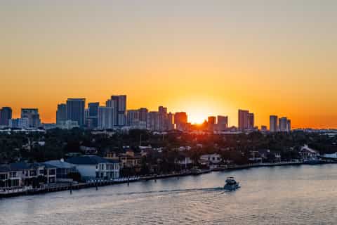 City skyline at golden sunset over waterfront residential area