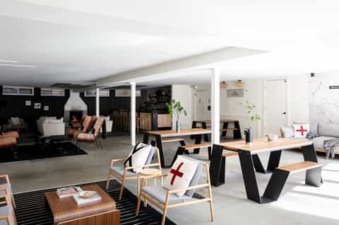 Contemporary hotel lounge with fireplace, wood furniture, and modern decor