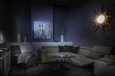 Elegant dark interior lounge with modern furnishings, decorative mirrors, and contemporary lighting design