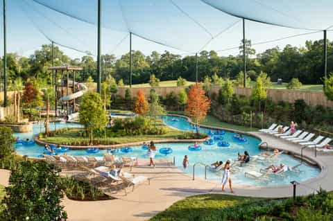 Family water park with lazy river, pools, waterslide, and covered seating areas