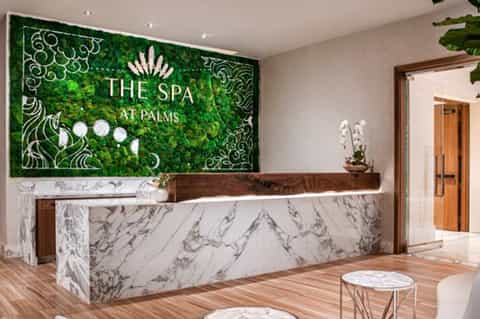 The Spa at Palms reception desk with living moss wall and marble counter