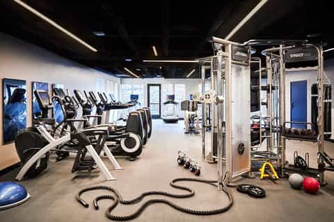 State-of-the-art fitness center with cardio equipment, weight machines, resistance ropes, and exercise balls