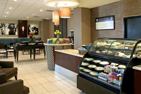Modern café interior with pastry display case and seating areas
