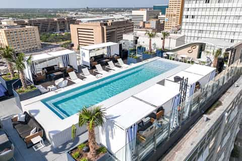 Modern rooftop pool on high-rise building with city skyline and river views