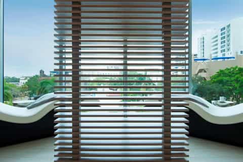 Balcony with modern slatted wood railing overlooking residential area and buildings