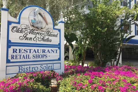 Olde Marco Island Inn & Suites entrance sign with colorful flower beds