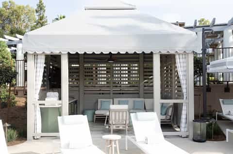White luxury tent pavilion with lounge seating and ocean views