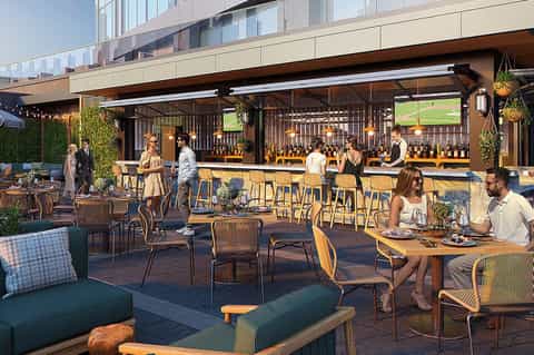 Modern rooftop bar and dining area with woven chairs and full-service bar