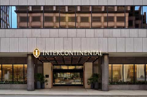 InterContinental hotel entrance with illuminated signage, glass doors, and modern architectural facade