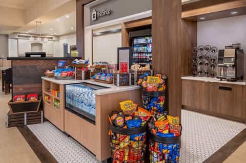 Modern hotel shop interior with snack displays and beverage coolers