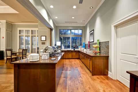 Luxury kitchen with wooden cabinetry, granite countertops, and glass-paned doors