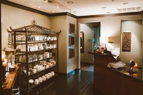 Spa reception area with decorative Asian-inspired shelving and product displays