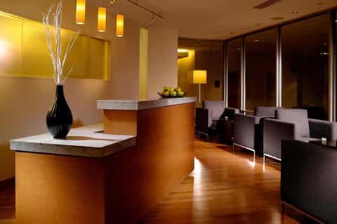 Elegant hotel lobby with warm lighting, wooden floors, and contemporary furniture