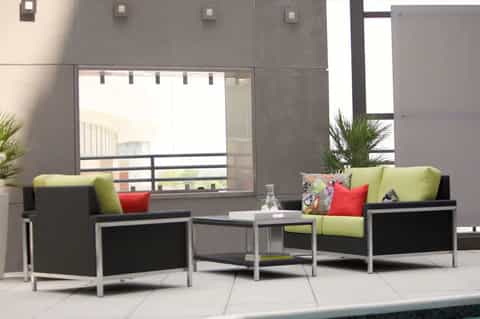 Contemporary outdoor lounge seating with lime green cushions on terrace