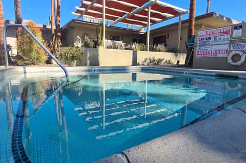 Indoor swimming pool with lap lanes, diving board, and covered observation area