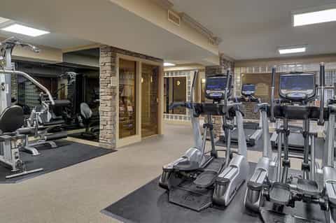 Modern fitness center with cardio equipment, exercise bikes, and treadmills in spacious room