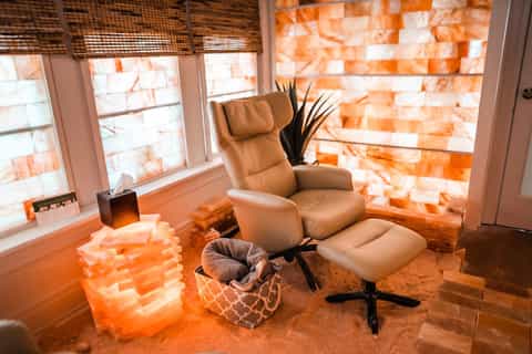 Wellness room with tan leather reclining chair, Himalayan salt lamp, and window with woven blinds