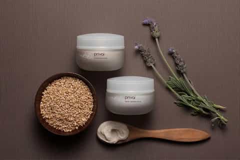 Spa products display with exfoliating scrubs, lavender sprigs, and wooden applicator