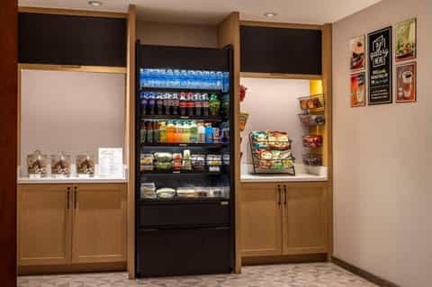 Hotel snack station with vending machine and display shelves