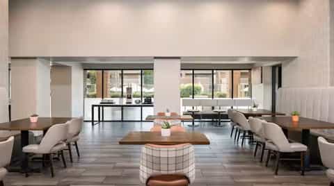 Modern hotel lobby with sleek furniture, columns, and contemporary design elements