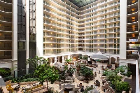 Modern hotel atrium courtyard with multiple floors and lounge seating area