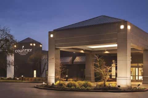 Country Inn & Suites modern entrance with stone facade and architectural canopy at night