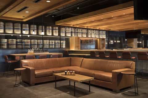 Contemporary bar lounge with cognac leather sectional sofa and craft beer tap display
