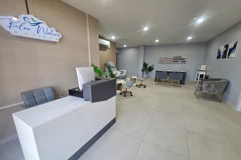 Modern hotel lobby reception desk with blue accent walls and contemporary seating area
