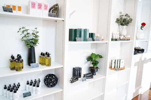 Retail shelves displaying spa products, candles, books, and wellness items