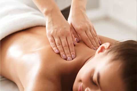 Professional spa massage treatment on client's back and shoulders