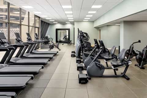 Modern fitness center with treadmills, stationary bikes, and weight equipment