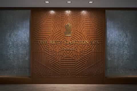 The Ritz-Carlton Spa Chicago ornate wooden entrance sign with art deco geometric patterns